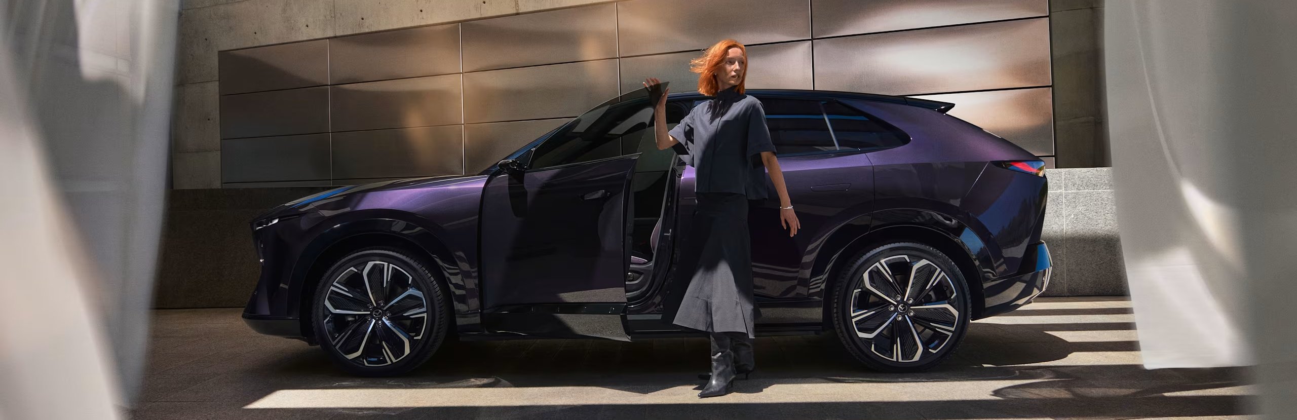 woman stood outside of a purple car